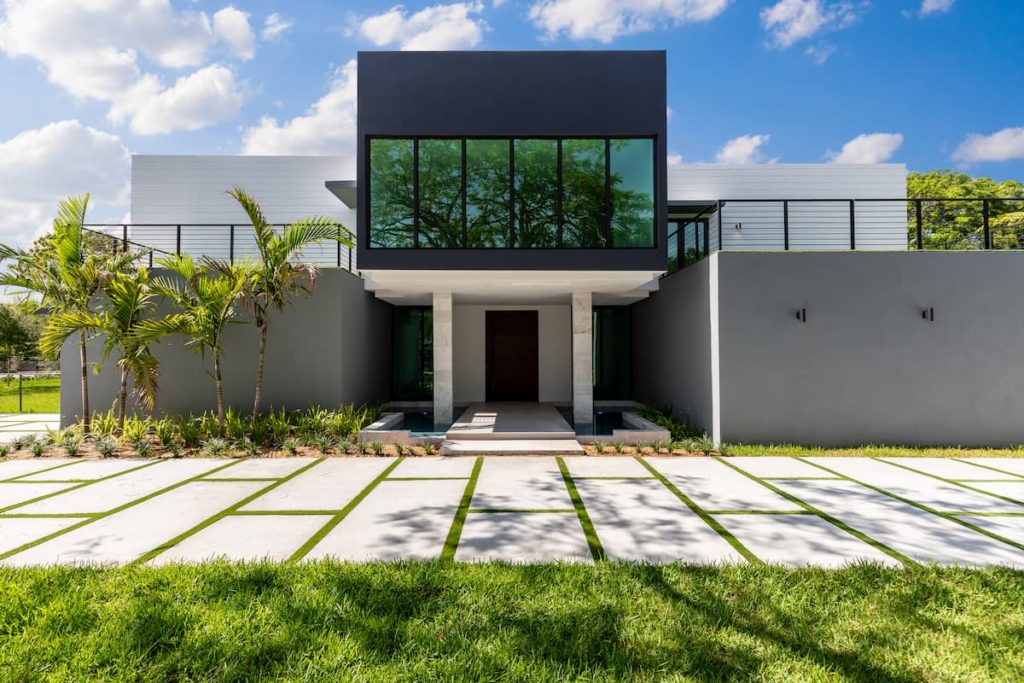 Tropical plant installation featuring palms and ornamental grasses in a Miami yard