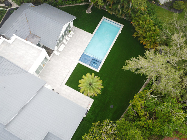 Artificial turf surrounding pool area