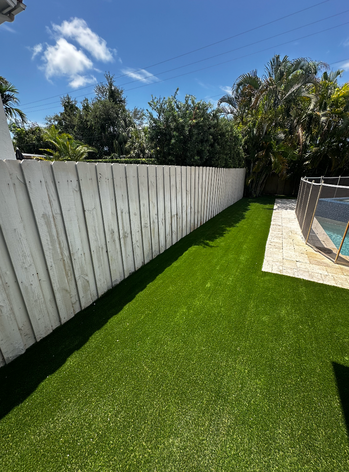 Artificial turf surrounding pool area for a clean and slip-resistant finish in Miami home