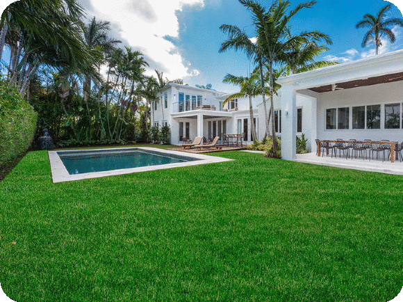 Grass sod installation creating a full green lawn in a Miami residential area