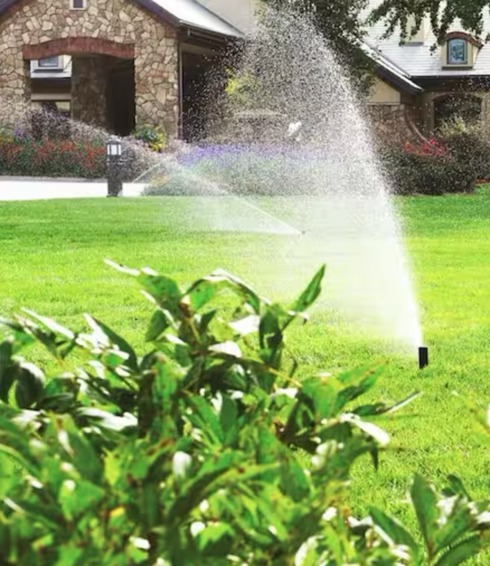Technician performing irrigation system repair for a Miami homeowner