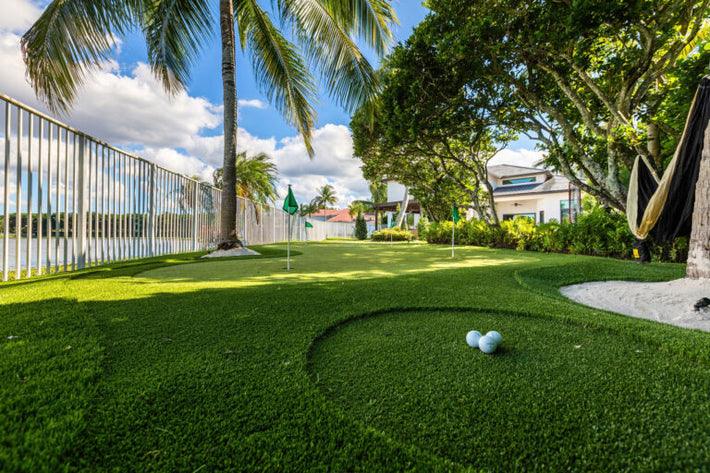 Luxury backyard putting green designed with fringe and contour in a Miami property
