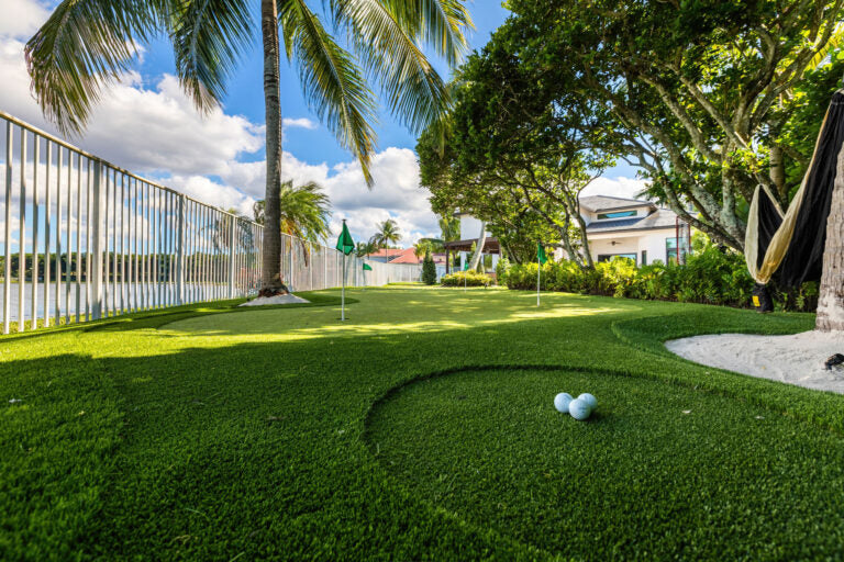 Luxury backyard putting green designed with fringe and contour in a Miami property