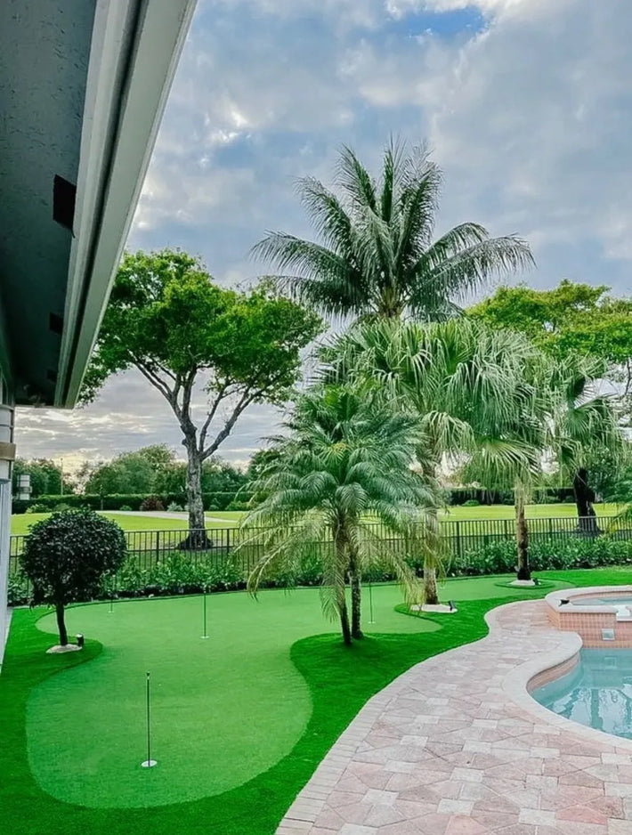 Personal golf putting green designed and built for private use in a Miami backyard